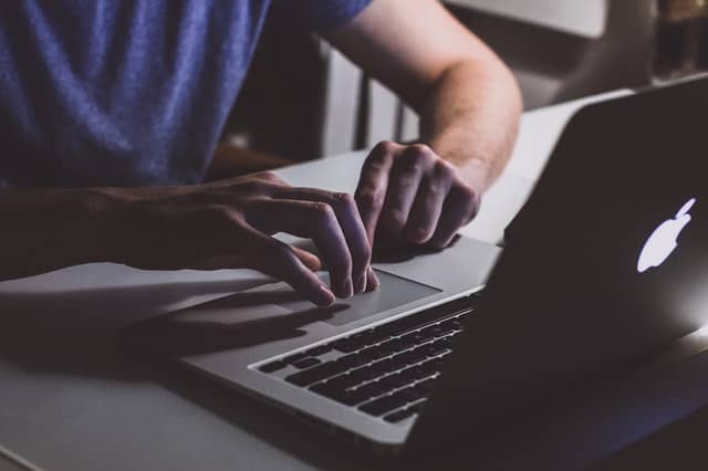 Person typing on laptop