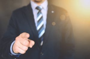 man in suit pointing at you